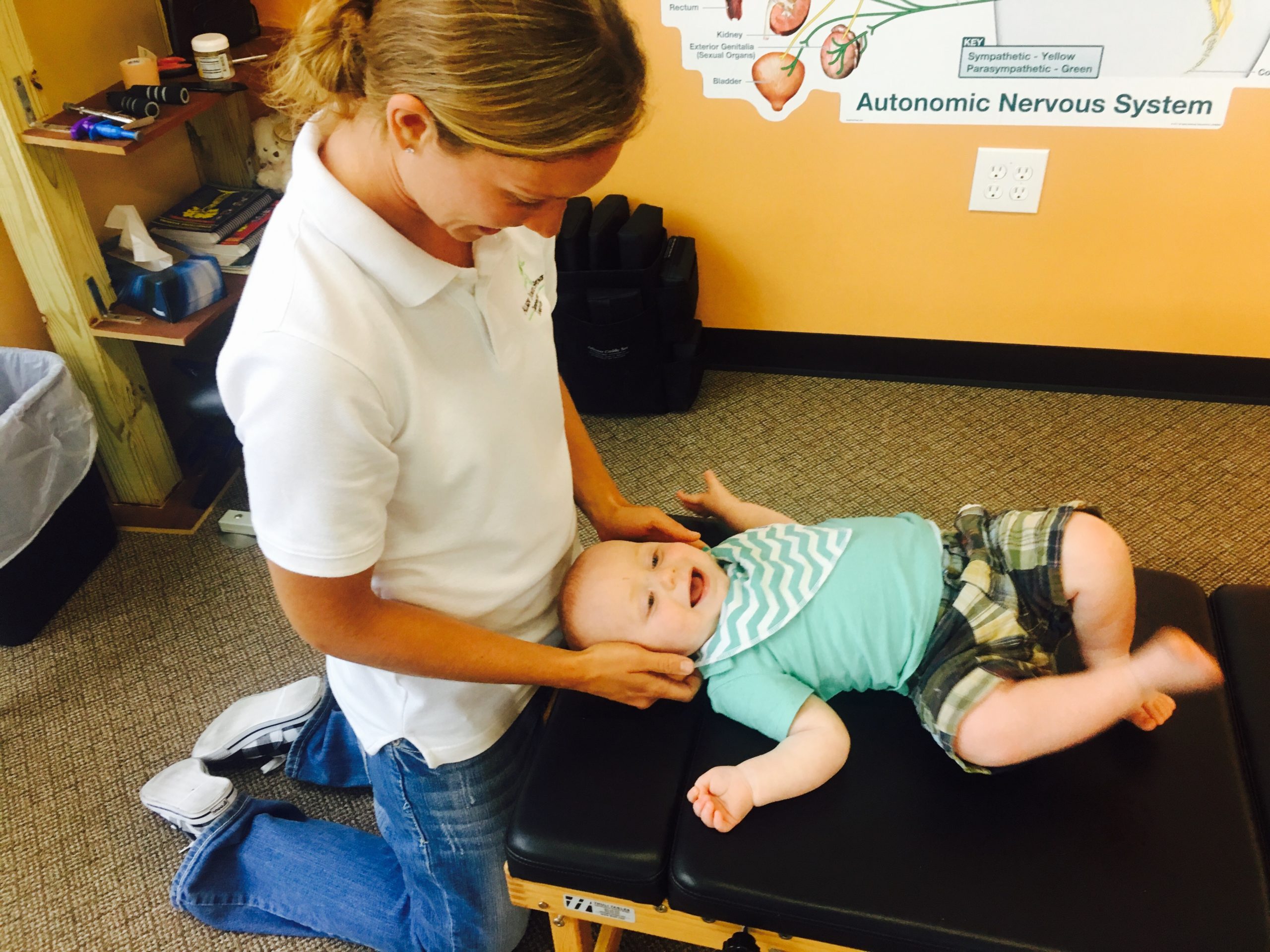 Pediatric Chiropractor Louisville KY Dr. Megan Socha adjusting a baby with pediatric chiropractor in Louisville.